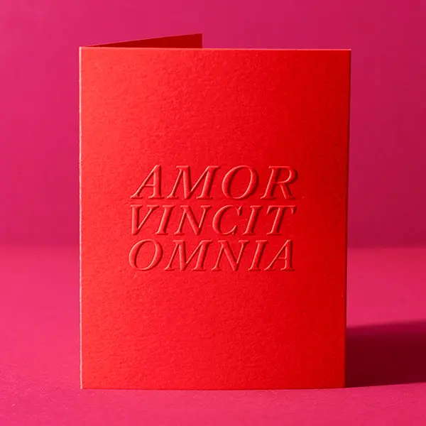 'Love Conquers All' Greeting Card 1